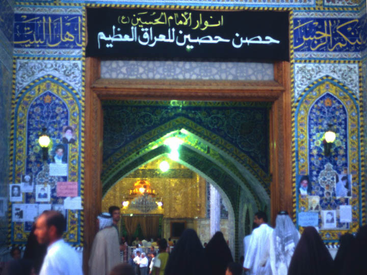 The black banner reads: "The light of Imam al-Hussein, protective of the great Iraq." ©2003 Derek Henry Flood